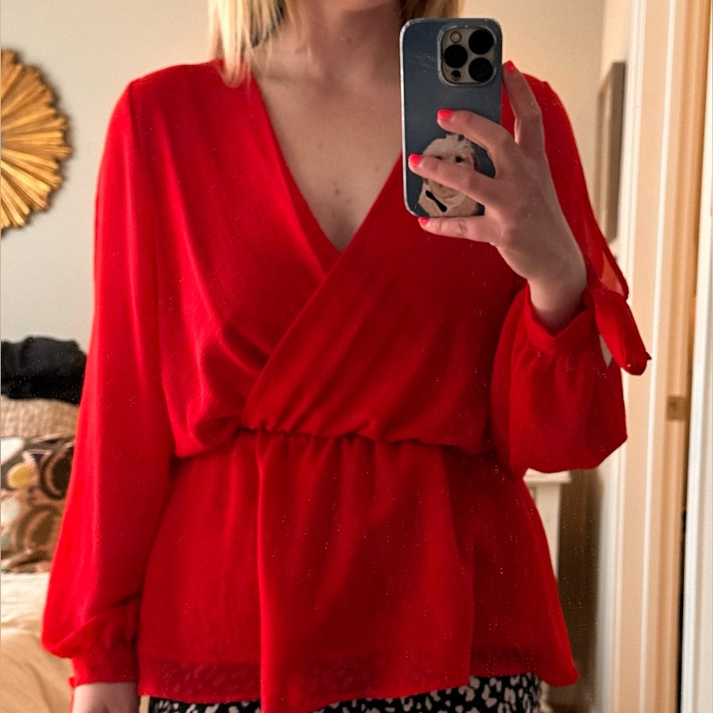 Lightly worn sheer red blouse with v neck, flare bottom and open sleeves